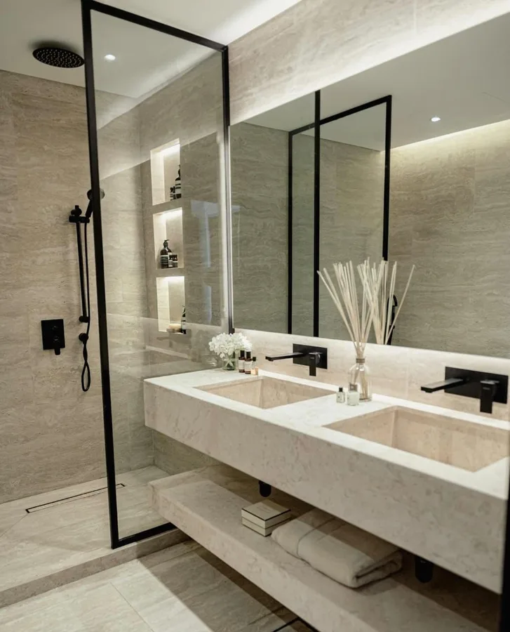 Framed glass shower screen and matching black framed mirrors in a Dubai villa bathroom
